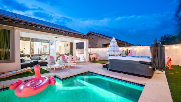 A modern outdoor pool area with a hot tub, lounge chairs, and a dining area. - Welcome to the Coco Cabana! Located in Estrella Mountain Ranch in Goodyear, AZ! (Goodyear)