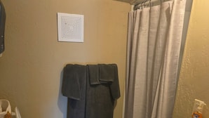 A bathroom with a toilet, a sink, and a shower curtain. - Hunter's Shack - Bear Cabin (Mayhill)