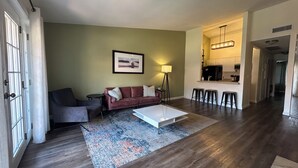 A modern living room with a sofa, coffee table, and a rug.