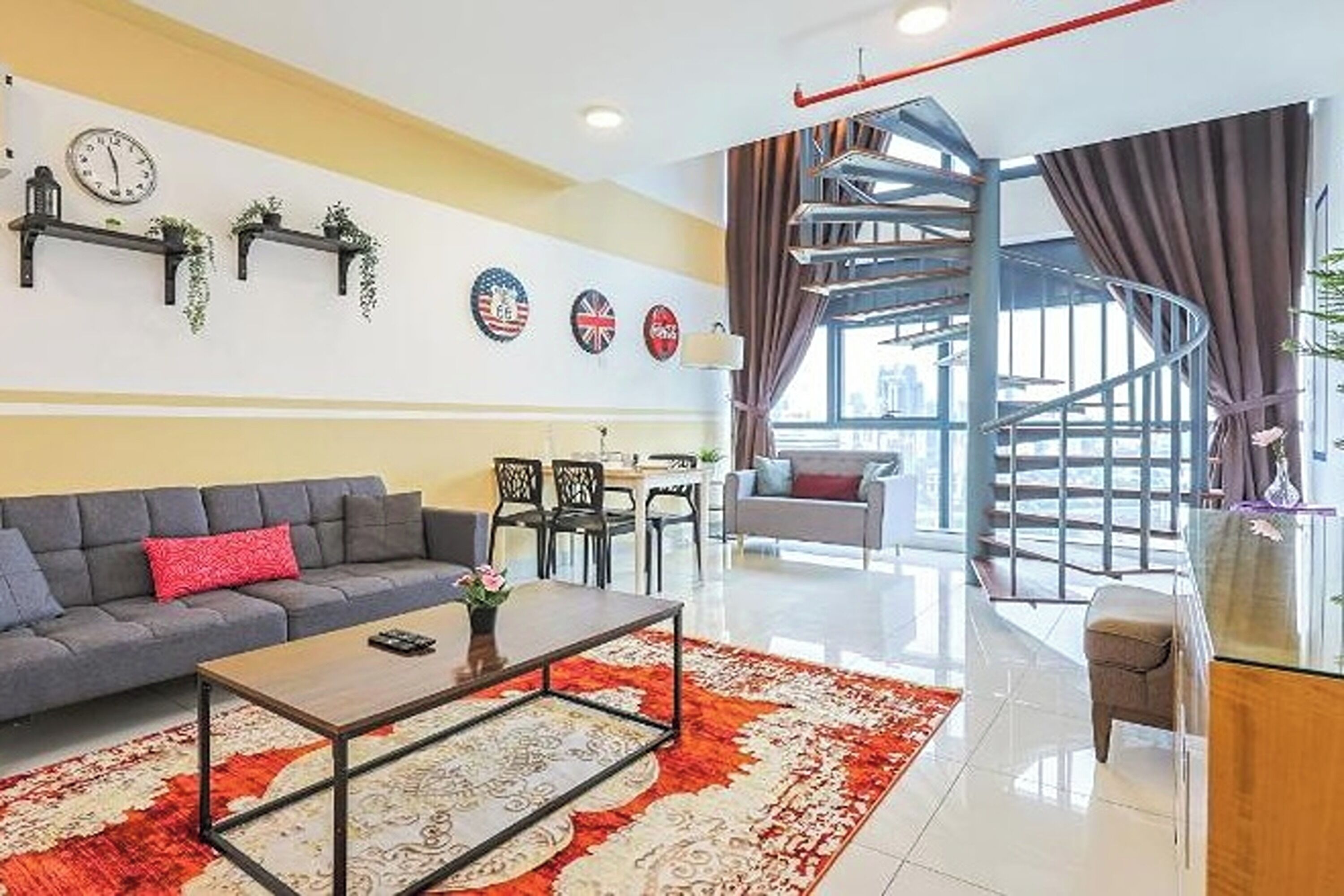 A modern living room with a sofa, coffee table, and a spiral staircase.