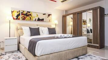 Une chambre à coucher moderne avec un lit, des tables de chevet, une armoire et des œuvres d’art abstraites accrochées au mur.