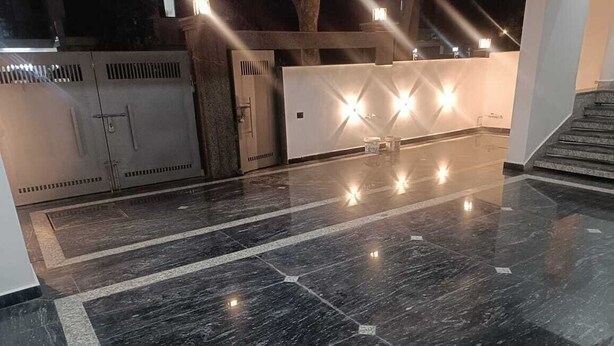 A lobby with a polished marble floor, a reception desk, and a staircase. - Cozy and Tranquil Nest ( With wifi and Homely Care ) (Greater Noida)