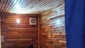 A small, cozy room with a bunk bed, a wooden slat ceiling, and a blue curtain. - Cuba linda  (Asunción)