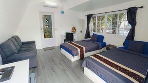 Une chambre avec deux lits, un bureau et un canapé.