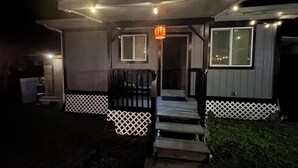 A house with a porch, steps, and a small garden area.