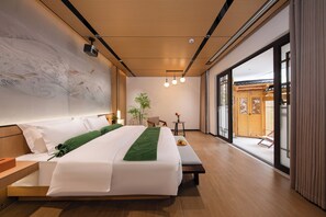 A modern hotel room with a large bed, a wooden floor, a large window, and a view of the outside. - The wonderland homestay (Deqin)