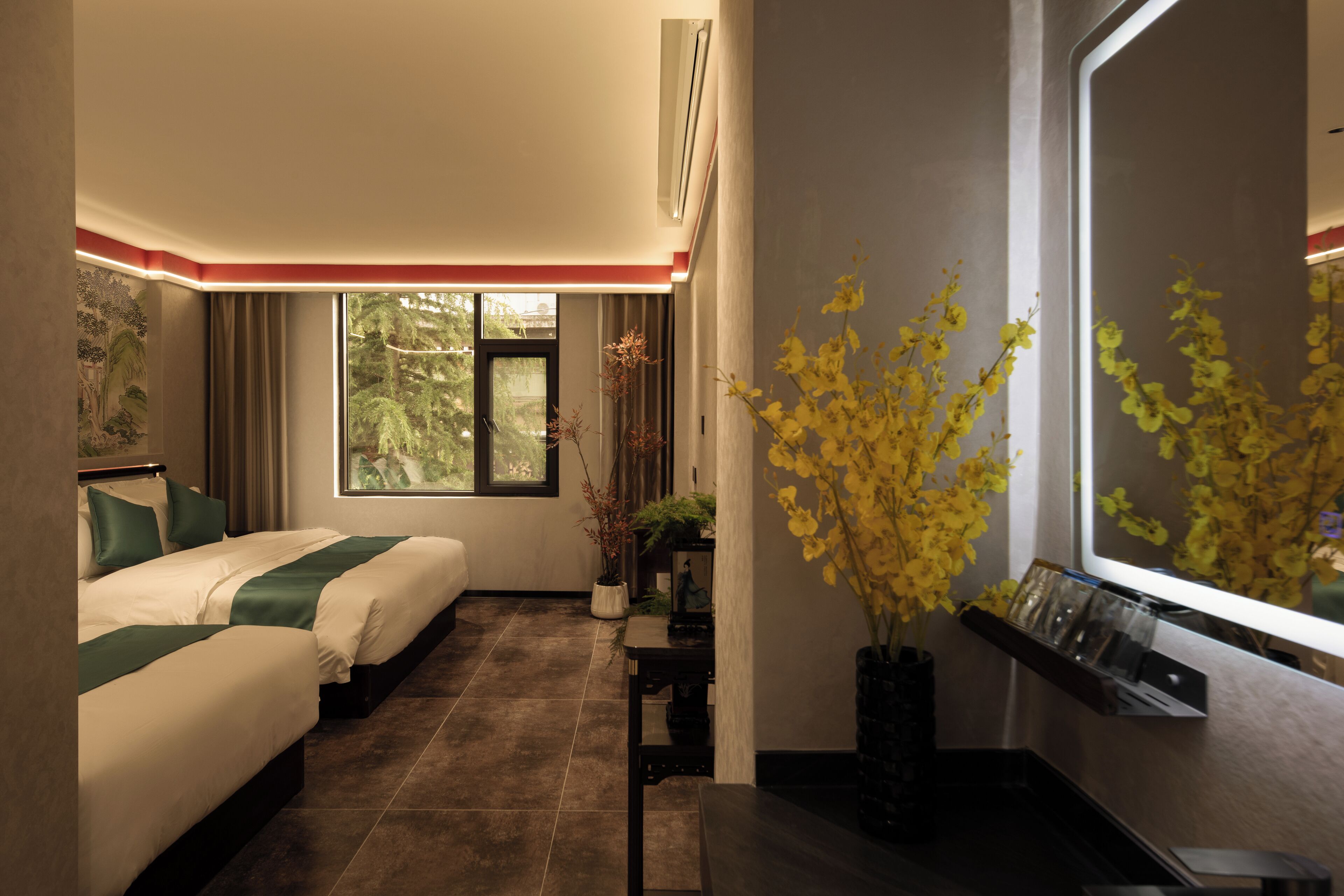 A hotel room with two beds, a large window, a potted plant, and a wall-mounted shelf.