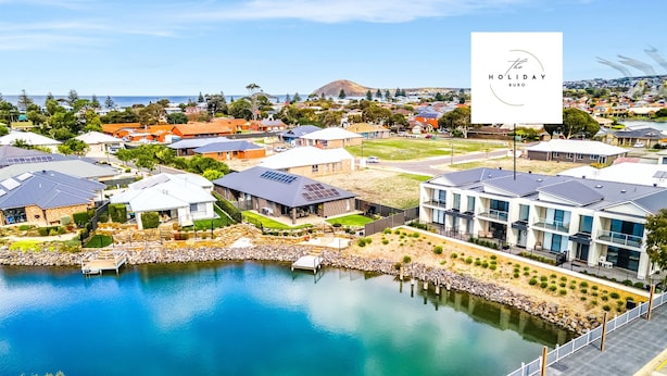 A residential area with modern houses, a dock, and a clear view of the water. - Waterside Victor Harbor (Victor Harbor)