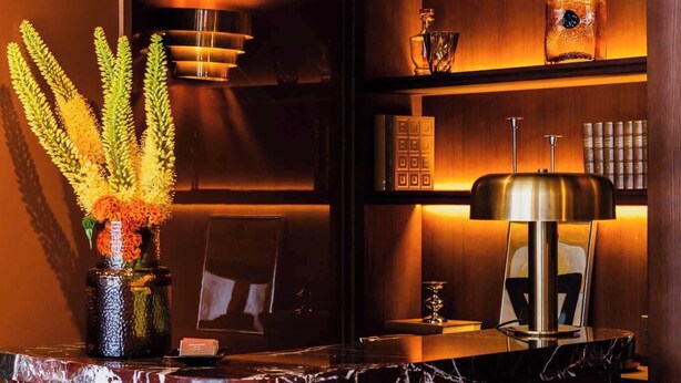 A modern bar area with a marble countertop, a vase with flowers, and a lamp. - Confidential Room 1, a Stone's Throw From the Louvre (Paris)