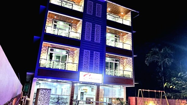 A multi-story hotel with a swimming pool in the foreground. - Soham Resort Diveagar (Shrivardhan)
