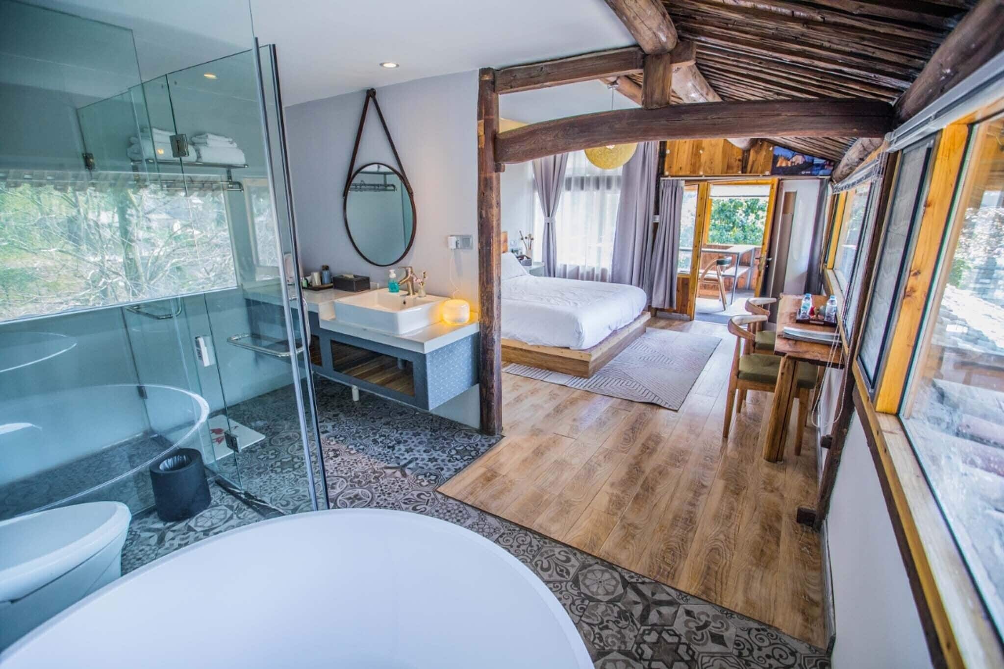 A modern bathroom with a glass shower enclosure, a white sink, and a large mirror.