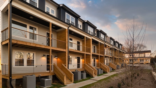 A multi-story residential building with balconies, staircases, and outdoor air conditioning units. - Sleeps 74 | 8 Nash Homes, 21 Bedrooms + Near Broadway | Cherokee by AvantStay (Nashville)