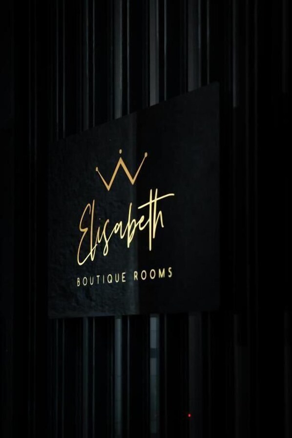 A sign with the name "Elisabeth Boutique Rooms" against a dark background with vertical lines. - Elisabeth Boutique Rooms (Trieste)