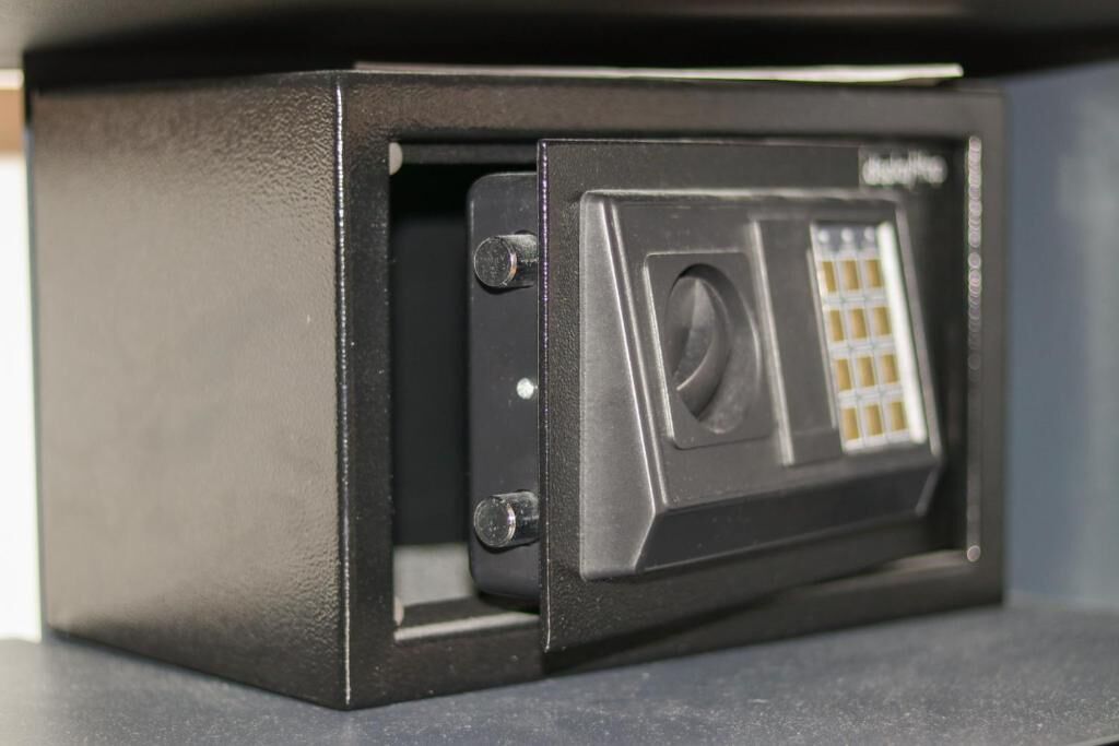 A secure safe with a combination dial and a keyhole.