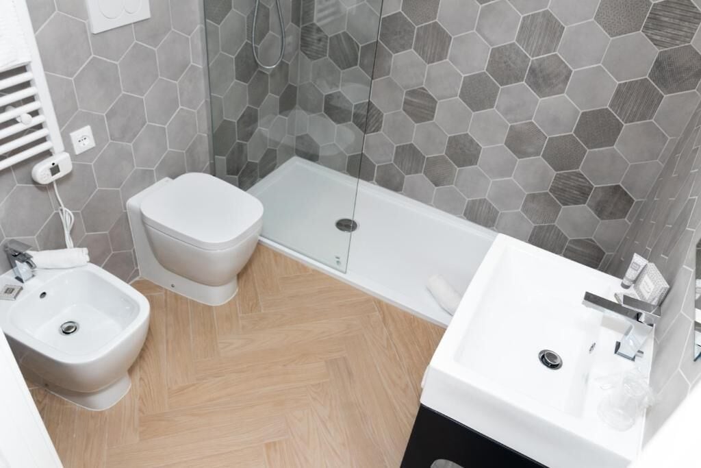 Ein modernes Badezimmer mit Toilette, Bidet und Badewanne.