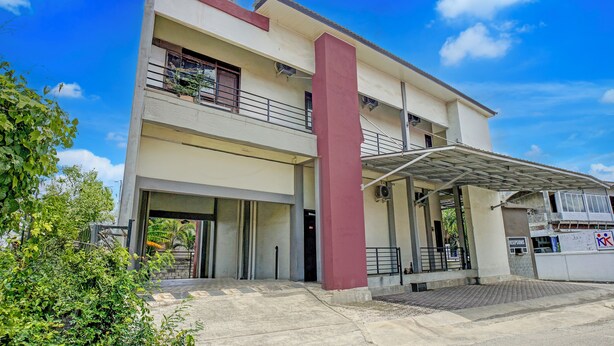 A two-story building with a covered entrance and a red pillar. - Hotel O Banda Aceh near UIN formerly Alif Guest House Syariah (Banda Aceh)