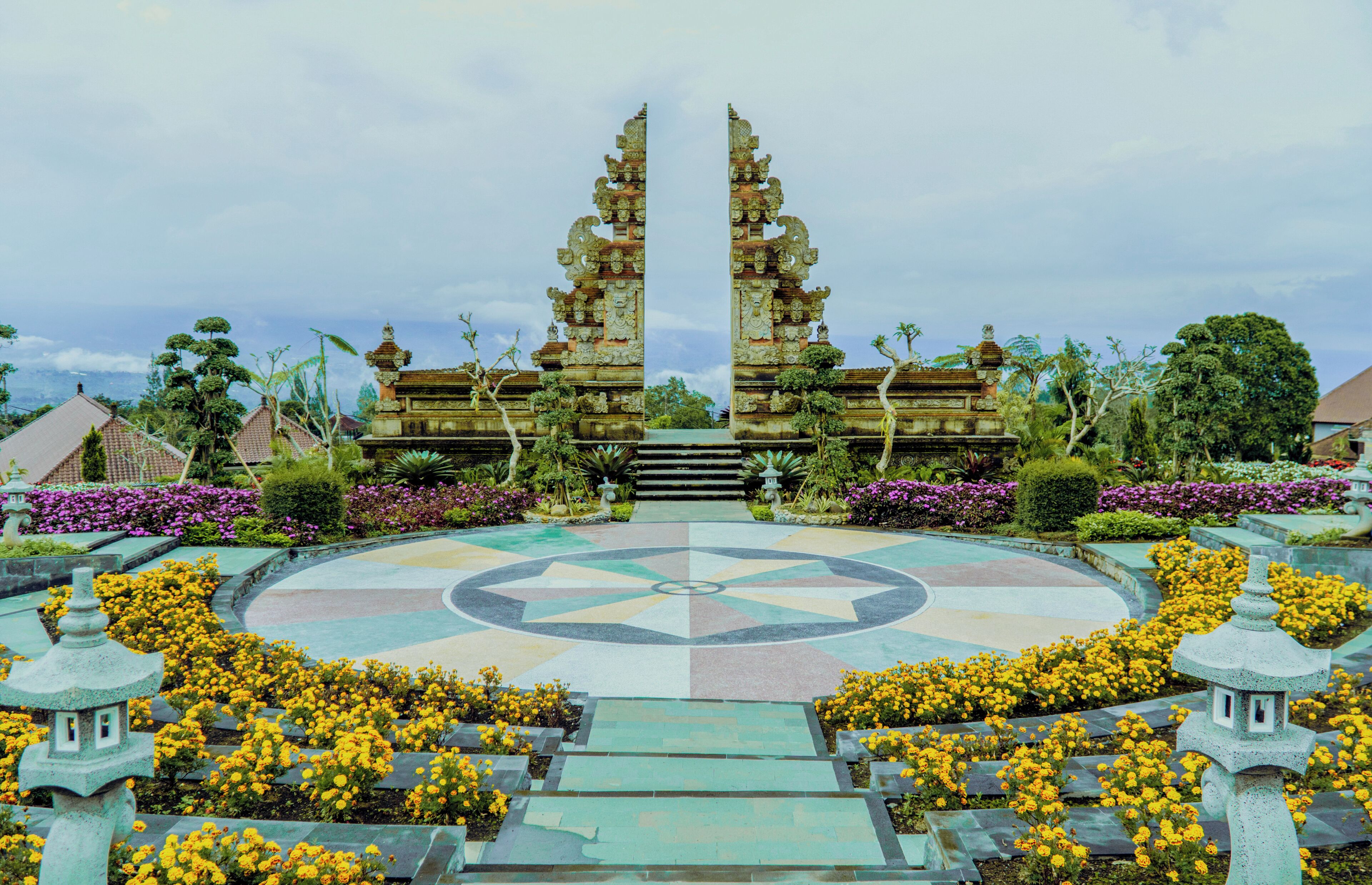 A symmetrical temple structure with a central circular mosaic and a symmetrical design.