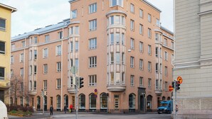 A multi-story building with a classic architectural style, featuring large windows and a central entrance with a balcony. - Hotel-standard design apartment with sea view (Helsinki)