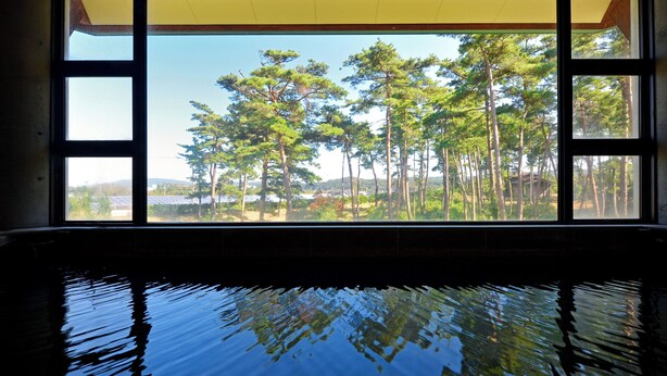 A room with a large window overlooking a forested area. - Hotel Wellness Notoji (Hodatsushimizu-cho)