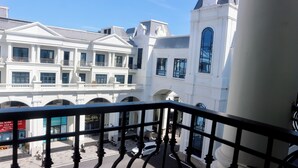 A multi-story building with classical architecture, including arched windows and balconies. - Blue Waves Hotel (Phu Quoc)