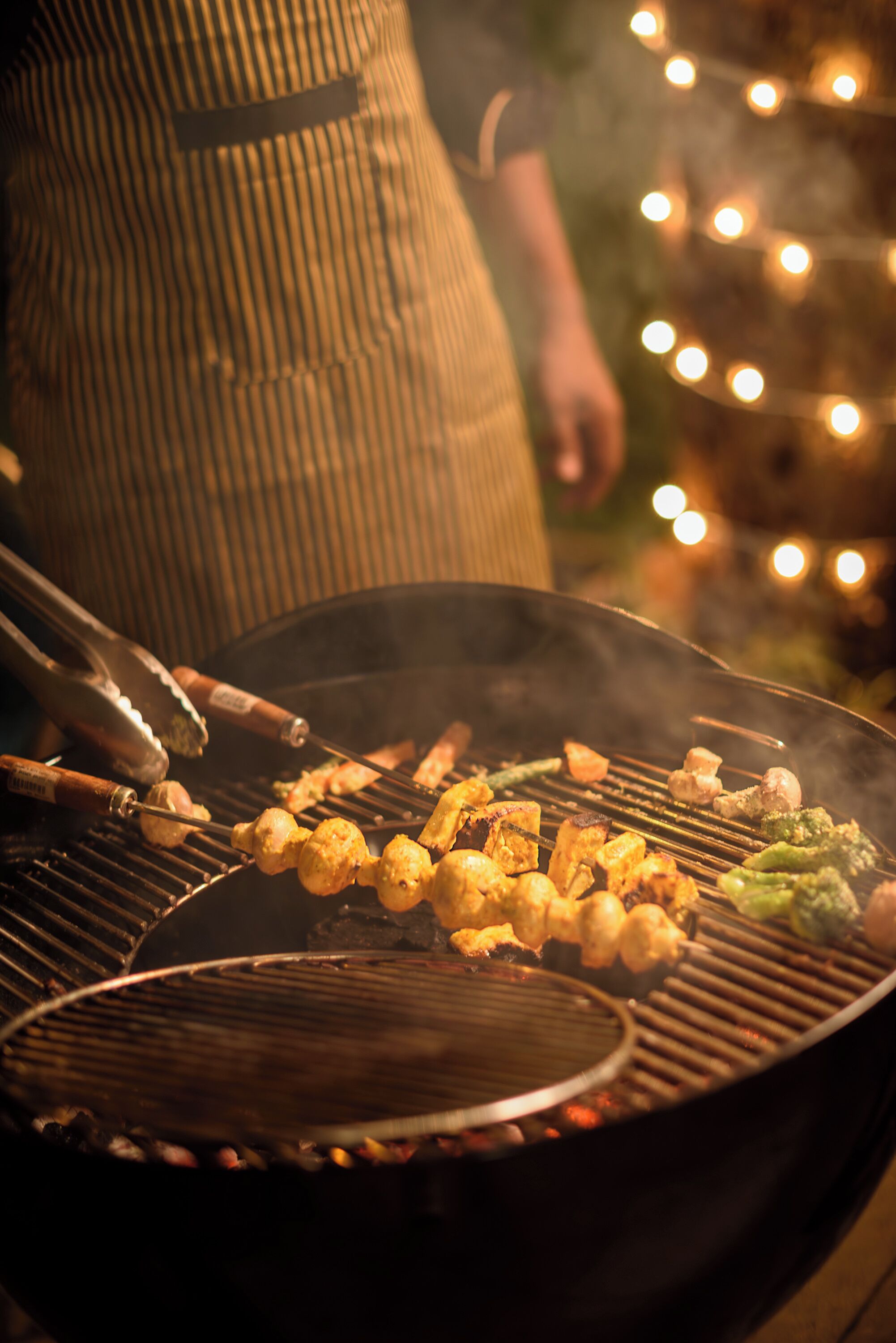 A grill with skewers of food being cooked.