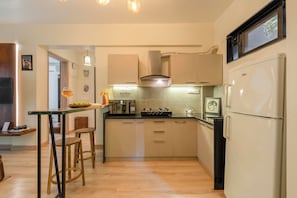Luxury Apartment, Garden View | Private kitchen | Full-size fridge, microwave, stovetop, coffee/tea maker
