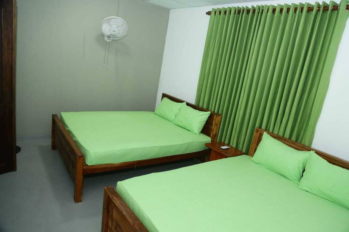Deluxe Quadruple Room | Desk, laptop workspace, iron/ironing board