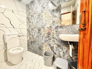 Shower, rainfall showerhead, bidet, towels