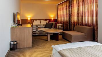 Deluxe Quadruple Room | In-room safe, desk, laptop workspace, iron/ironing board