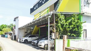 A parking garage with multiple cars parked inside.