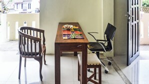 A dining area with a wooden table, a bench, and a chair.