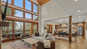 A spacious living area with a large window, a fireplace, and a cozy seating arrangement.