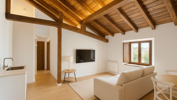 A modern living room with a wooden ceiling, a flat-screen TV, a sofa, and a dining area. - Otero de Campoo (Hermandad de Campoo de Suso)