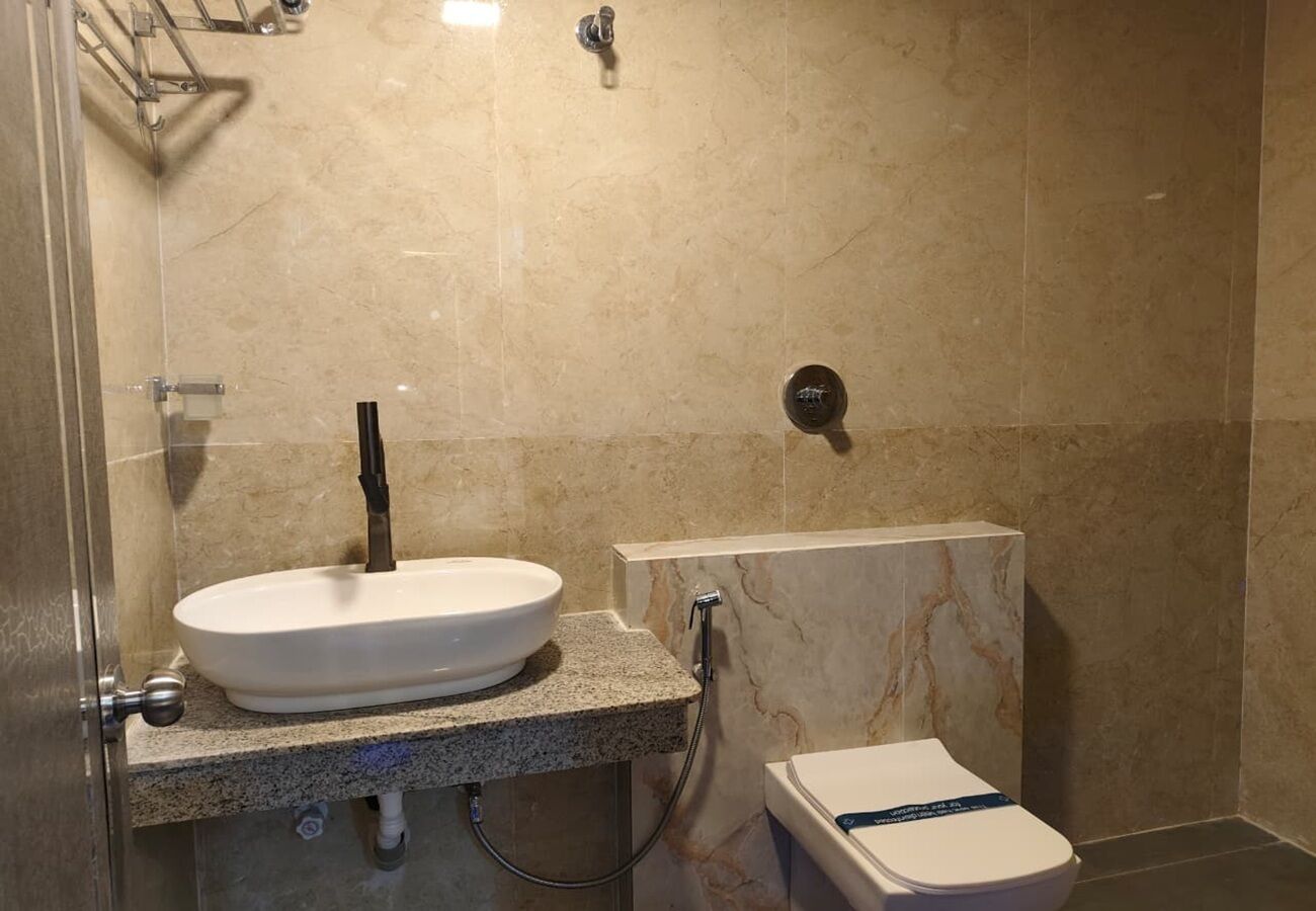 Une salle de bain avec un lavabo, des toilettes et une douche.