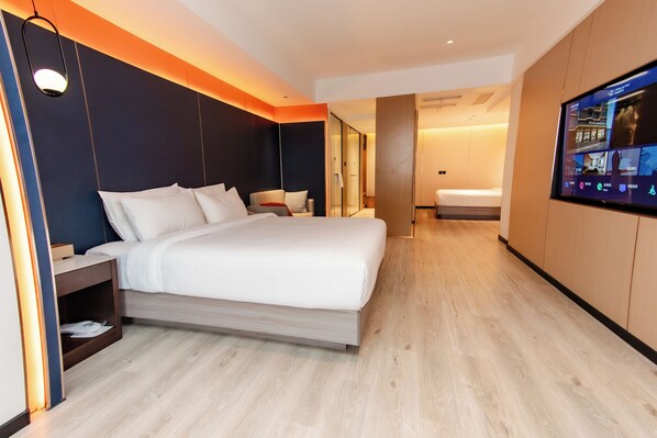 A modern hotel room with a large bed, a TV mounted on the wall, and a wooden floor. - Jiuding Joy Hotel (Kathmandu)
