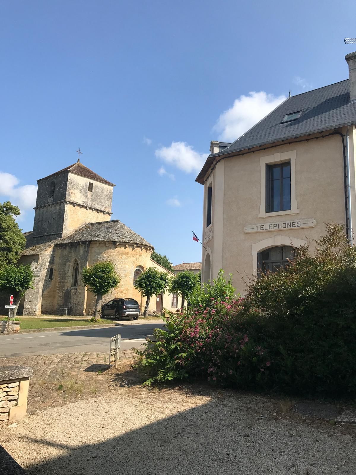 A building with a sign reading 'TELEPHONES' and a bell tower.