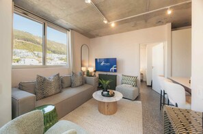 Two Bedroom Apartment | Living area | Smart TV, Netflix, streaming services - ONEHUNDRED on M - Fluent Serviced Apartments (Cape Town)
