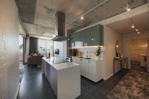 Three Bedroom Apartment | Private kitchen | Full-size fridge, microwave, oven, stovetop - ONEHUNDRED on M - Fluent Serviced Apartments (Cape Town)