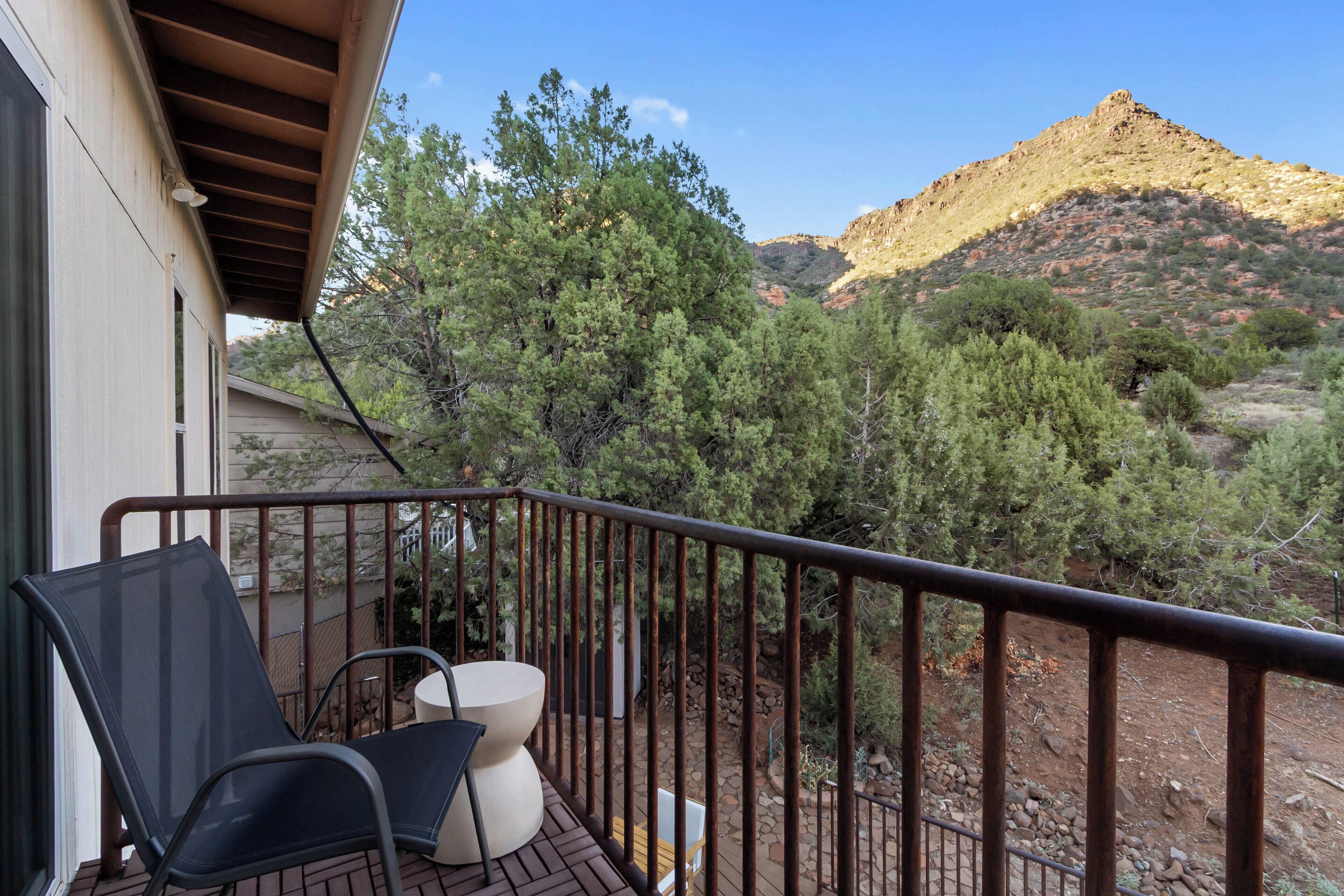 A balcony with a view of a mountainous landscape.