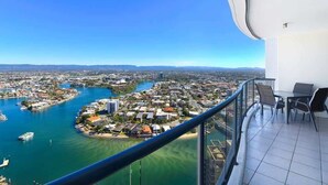 A balcony with a view of a coastal cityscape, including a marina and buildings. - The Lookout-Level 33 (Surfers Paradise)