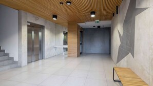 A modern interior with a wooden ceiling, tiled floors, and a bench.
