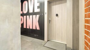 An elevator with a door marked '2' and a wall with the text 'LOVE PINK'.