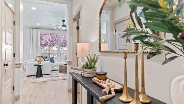 A modern living room with a sofa, a coffee table, and a console table with decorative items.