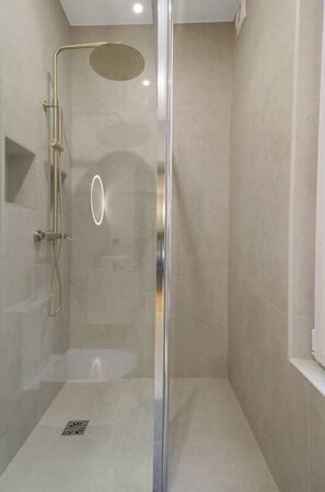 Shower, hair dryer, towels, shampoo