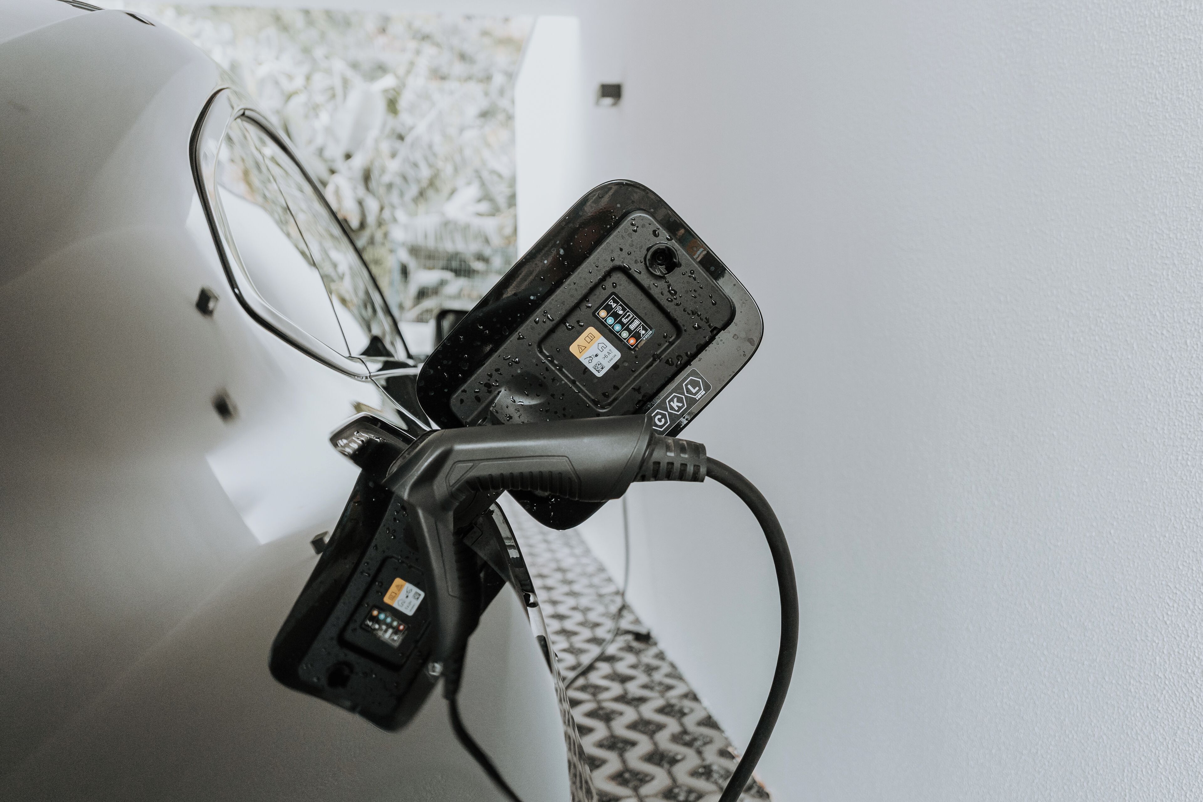 A car charging station with a cable connected to a vehicle.