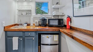 A compact kitchen with a sink, toaster, coffee maker, microwave, and a refrigerator. - Little House at Saskadena, right at the base of Ski Hill (Pomfret)