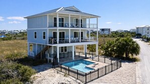 A two-story building with a pool, balconies, and a beach view. - Secluded Dunes gulf view with elevator, private pool, VayK Gear (Port St Joe)