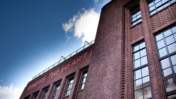 A brick building with large windows and a sign that reads "WHERE THE HEART IS". - Student Only Algernon Firth (Leeds)