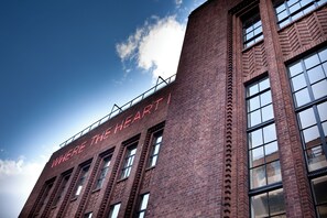 A brick building with large windows and a sign that reads "WHERE THE HEART IS". - Student Only Algernon Firth (Leeds)
