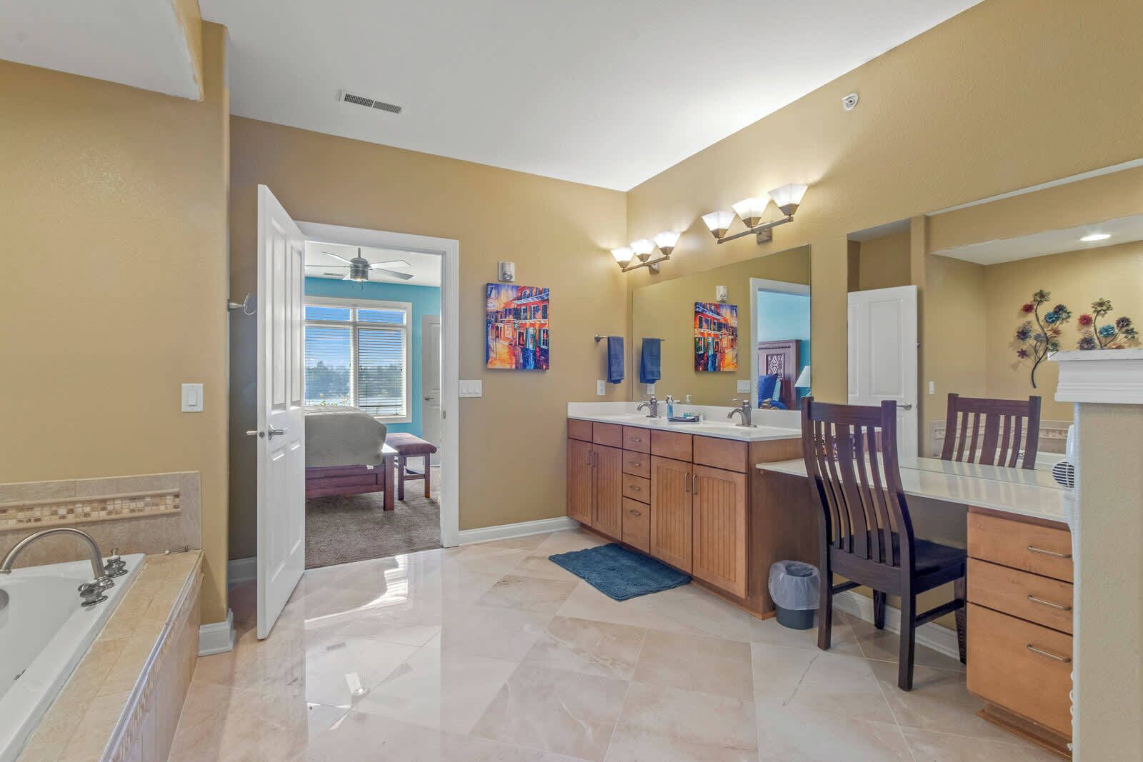 A bathroom with a bathtub, vanity, and a shower.